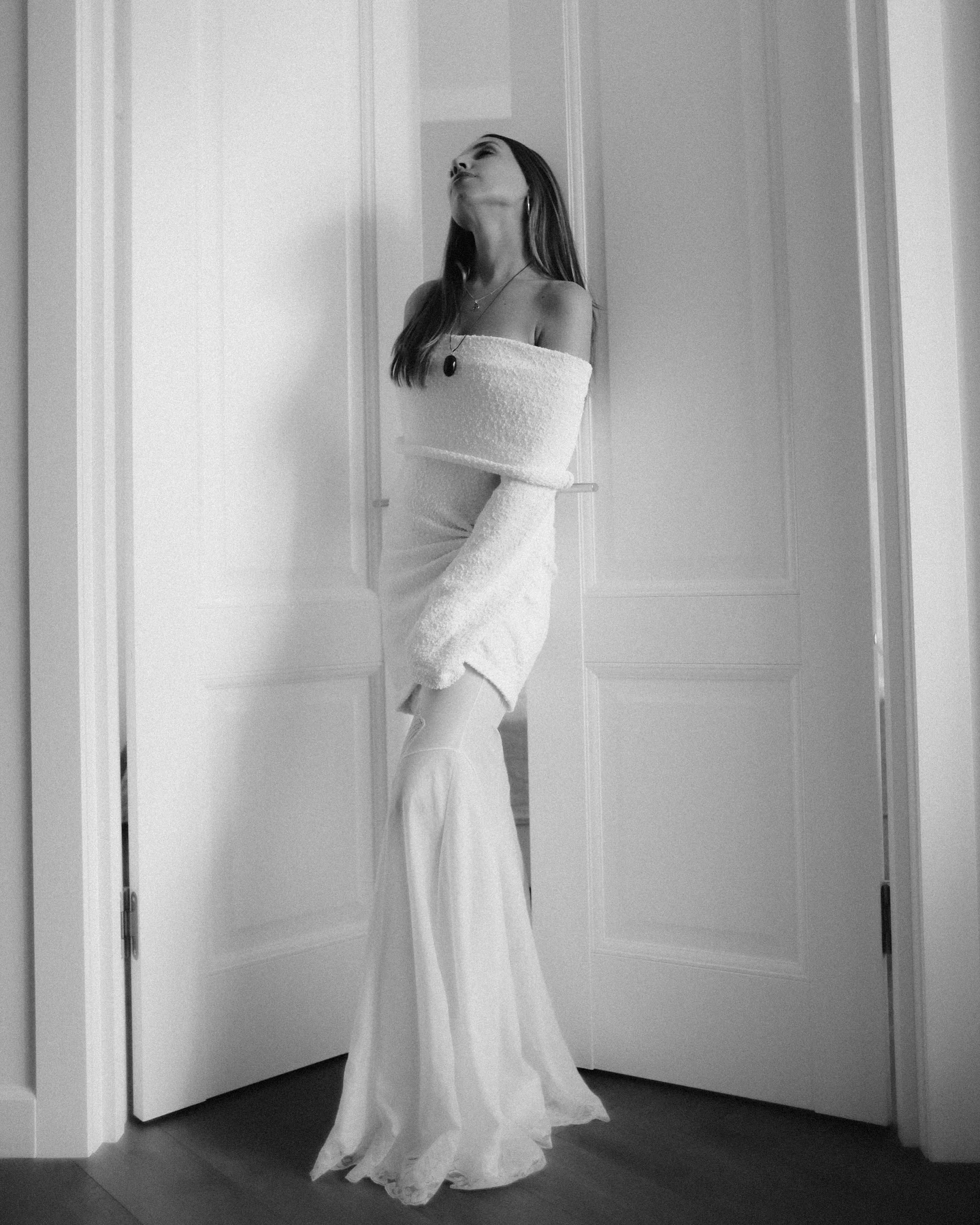 Black and white portrait of a woman in a flowing white dress
